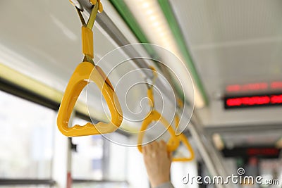 Grab pole with handgrip handles in public transport Stock Photo