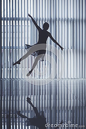 Graceful ballet dancer jumping near the window Stock Photo