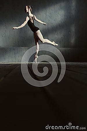 Graceful ballet dancer standing on the tiptoe in the studio Stock Photo