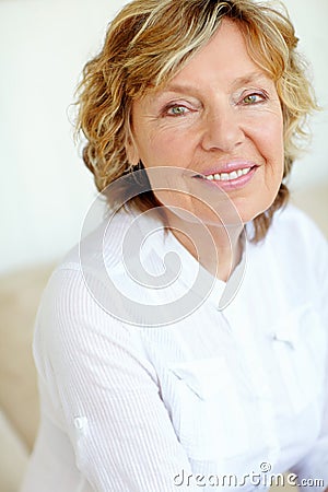 Graceful elegance. Closeup portrait of a graceful senior woman smiling at you happily. Stock Photo