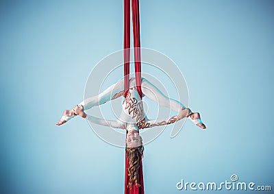 Graceful gymnast performing aerial exercise Stock Photo