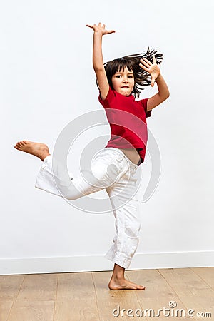 Gracious beautiful young girl dancing, showing joyous dynamic child movement Stock Photo