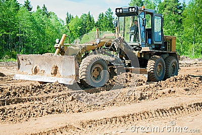 The grader clears away a ground Stock Photo
