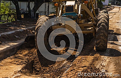 Grader is working on road construction. Grader industrial machine on construction of new roads. Heavy duty machinery Stock Photo