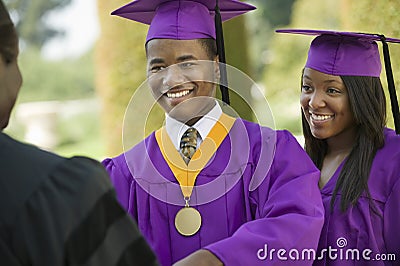 Graduate Looking At Cropped Dean With Friend Stock Photo