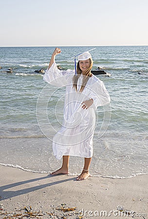 Graduate Posing On The Beach Stock Photo