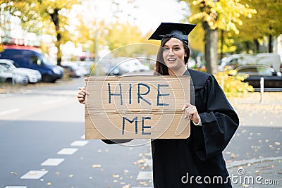 Graduate Student Standing With Hire Me Placard Stock Photo