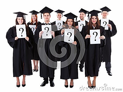 Graduate students holding question signs Stock Photo