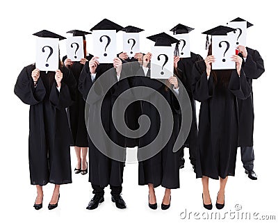 Graduate students showing question signs Stock Photo