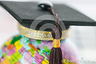 Graduate study abroad concept, Graduation cap on top Earth globe model map on laptop with Radar background. Graduate study abroad Stock Photo