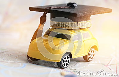 Graduate study abroad inter school concept : Graduation cap over yellow car on Bangkok city map, road to succes in life. Stock Photo
