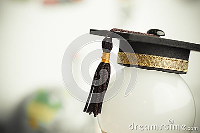 Graduate study or Education knowledge is power concept: Graduated cap Put on white light bulb and graph background. Conceptual for Stock Photo