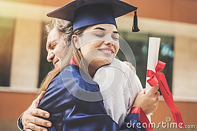 Graduated student hugging her father Stock Photo