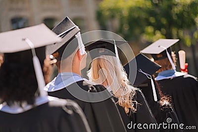 Graduates going away after receiving masters degree. Stock Photo