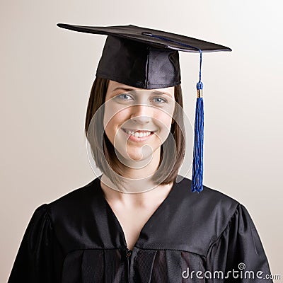 Graduating student wearing cap and gown Stock Photo