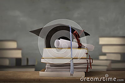 Graduation cap above stack books with degree paper Stock Photo