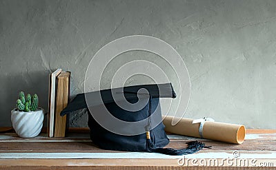 graduation cap, hat with degree paper on wood table graduation c Stock Photo