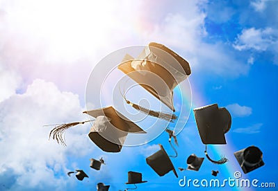 Graduation caps, hat thrown in the air with sun ray blue sky abs Stock Photo