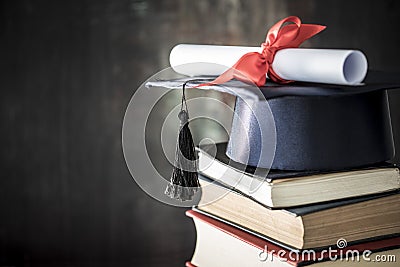 Graduation hat and diploma on table Stock Photo