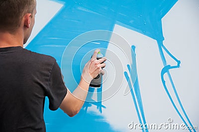 Graffiti artist hands with paint cans Editorial Stock Photo