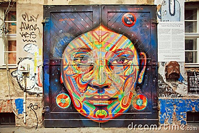 Graffiti with beautiful face of ethnic lady on the rustic door Editorial Stock Photo