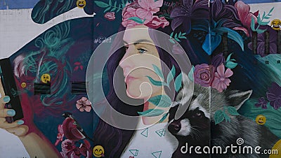 Graffiti of a beautiful girl with flowers Editorial Stock Photo