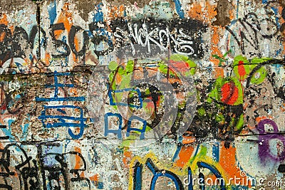 Layers of graffiti chaos scribbled and painted on a wall. Stock Photo