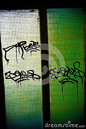 Graffiti on a glass door. Stock Photo