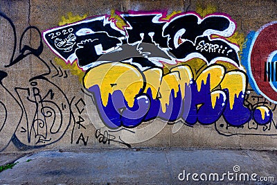 Graffiti message. Spary graffiti drawing on city block walls. Texture on cement. Editorial Stock Photo