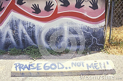 Graffiti reading ï¿½Praise God not menï¿½, South Central Los Angeles, California Editorial Stock Photo