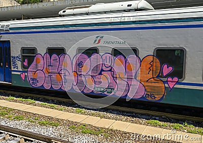 Graffiti on a train in the trainstation in Camogli, Northern Italy Editorial Stock Photo