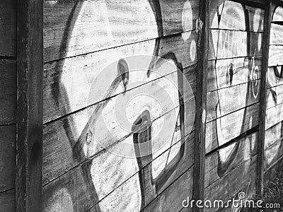 Graffiti vandalism on wooden wall. Stock Photo