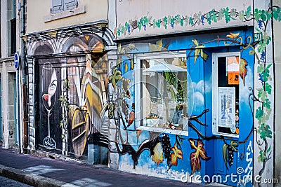 Graffiti wall background. Wine store in Perouge. France Editorial Stock Photo