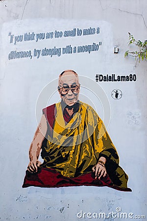 Graffiti on white wall representing the Dalai Lama Editorial Stock Photo