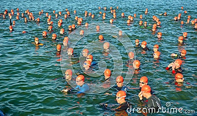 Competitors waiting in water to start swimming stage of triathlon, Editorial Stock Photo