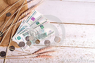 Grain ears on burlap and Russian money on the table, the concept of rising bread prices Stock Photo