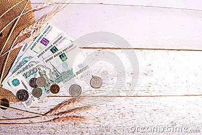 Grain ears on burlap and Russian money on the table, the concept of rising bread prices Stock Photo