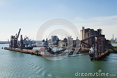 Grain elevator in harbour with terminal and cranes Stock Photo