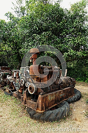 Grain Image: Close up of old machine factory made of steel and used in the past. Broken and rustic machine left over in abandon fa Stock Photo