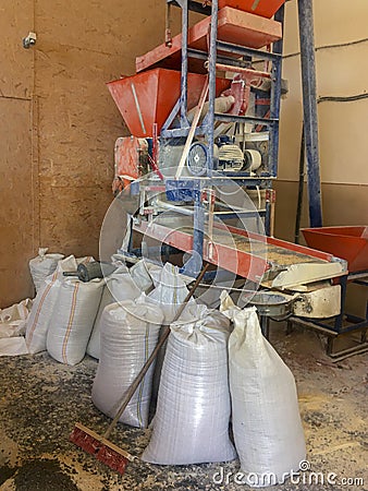 Grain sacks and a electric mill Stock Photo