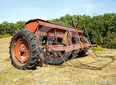 Grain seeder stands on the edge of the field Stock Photo