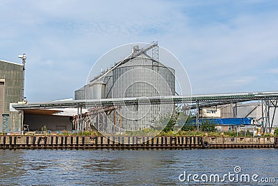 grain silos are located in a transhipment port Stock Photo