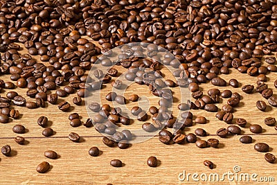 Grains of invigorating coffee on a wooden table Stock Photo