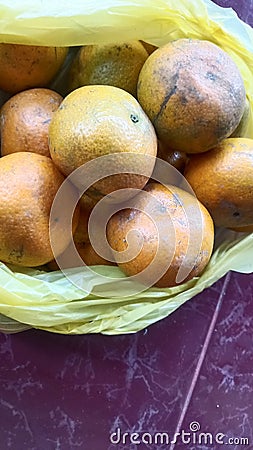 grainy and blurry picture of orange fruit bunch of oranges round yellow skin fruit Stock Photo