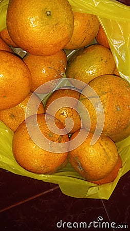 grainy and blurry picture of orange fruit bunch of oranges round yellow skin fruit Stock Photo