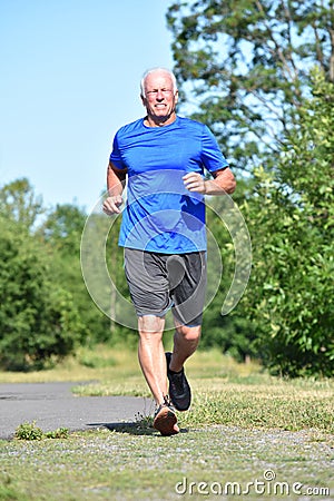 Grampa And Happiness Wearing Sneakers Running In Park Stock Photo