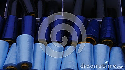 Gran rolls, partly covered with dust, in shades from light blue to dark blue, stored a box. raw material for handicraft Stock Photo