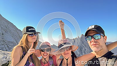 GRAN SASSO, ITALY - AUGUST 23, 2023: Portrait of four happy hikers along the pathway to the summit of Gran Sasso massif Editorial Stock Photo