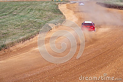 gran turismo races on the autocross track, skidding, dust and dirt from under the tires Stock Photo