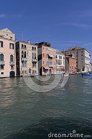 Grand Canal, historic decorative tenement houses, floating boats, Venice, Italy Editorial Stock Photo